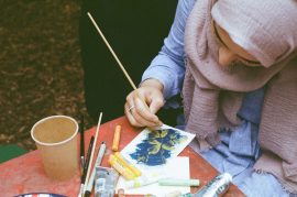 Photograph of young woman painting