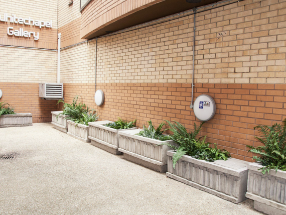 A view of an alley with concrete planters