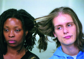 two figures, a black female and a white male, with their hair braided together