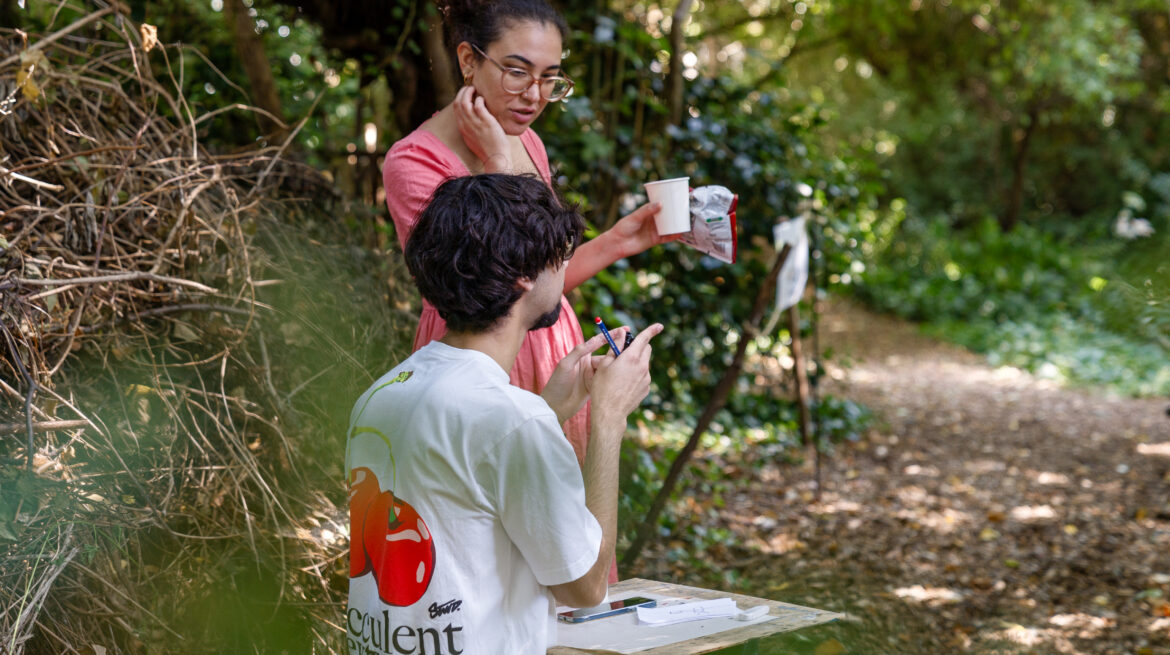 Two artists in conversation in woodland area